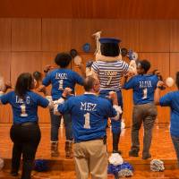 Image of TRIO advisors and directors showing off their nicknames on the back of their tshirts